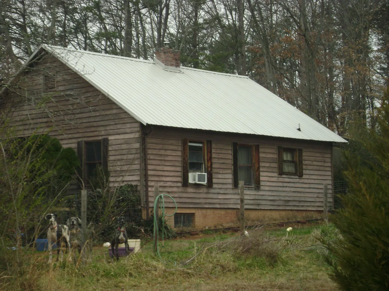 White metal roof on an old wood sided farmhouse, from a Metal Roof Installation job in Monponsett
